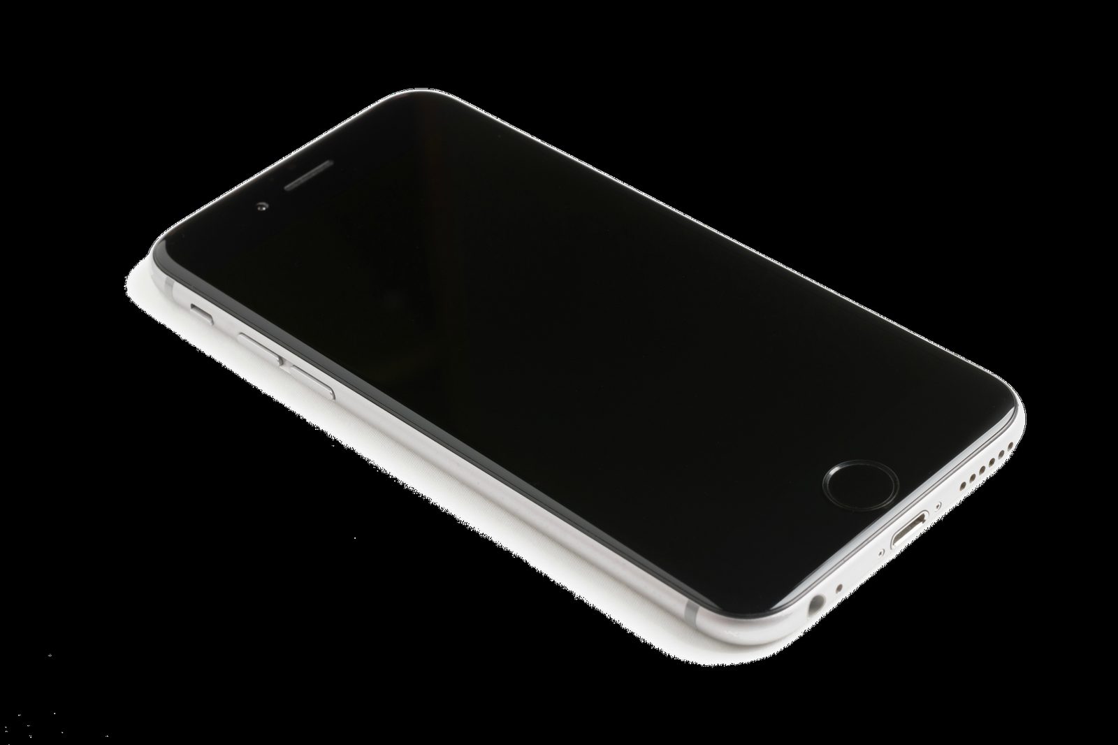 Smartphone blanc à écran éteint posé sur une surface noire, vu en diagonale